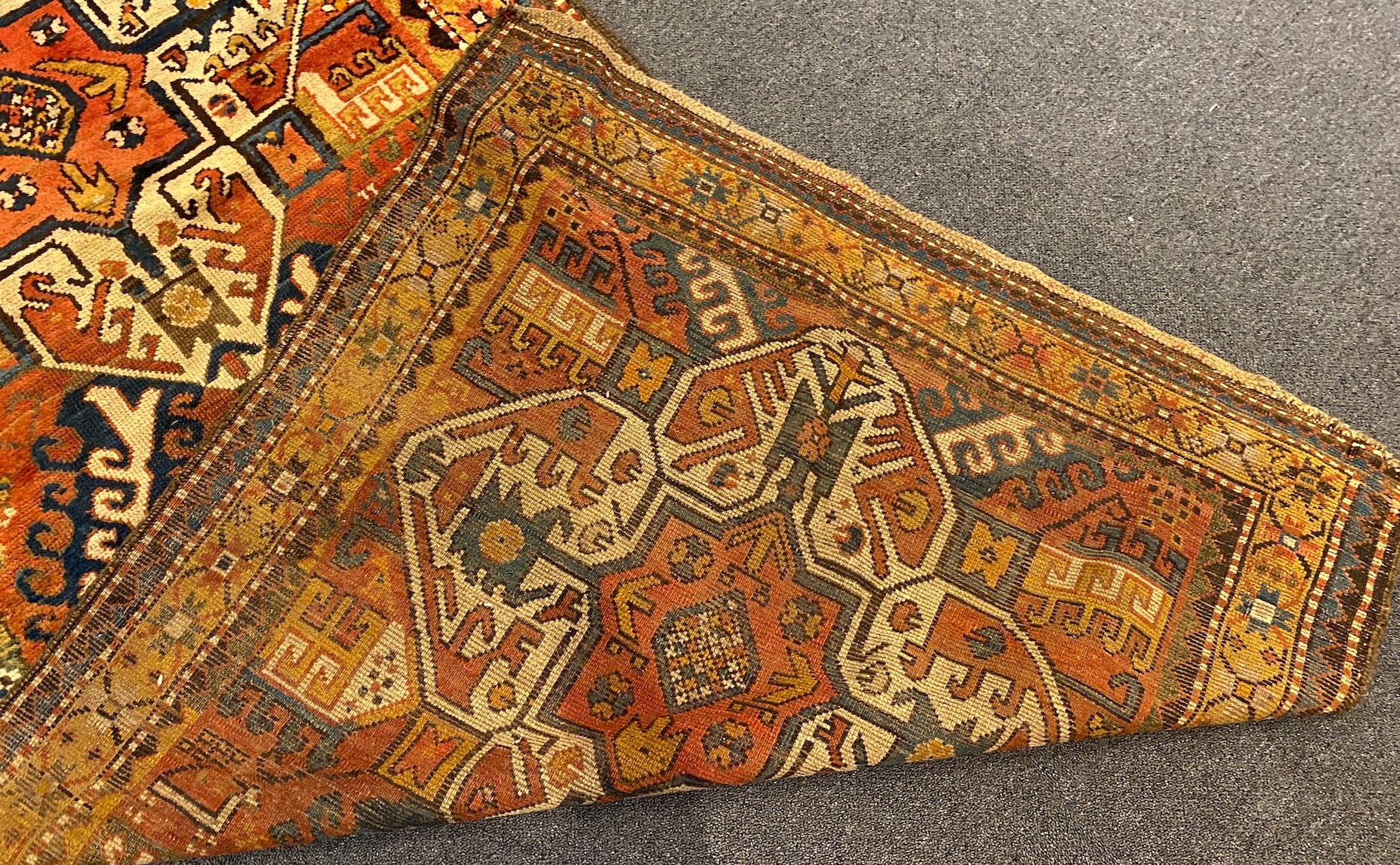 A Kazak red ground rug, 240 x 108cm